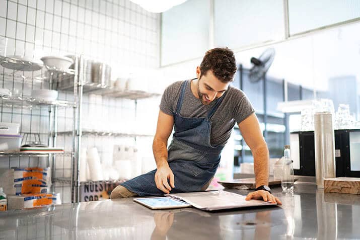 Restaurant manager reviewing 2021 sales